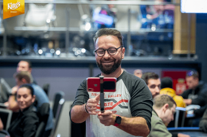 Daniel Negreanu holding a smartphone attached to a selfie stick.