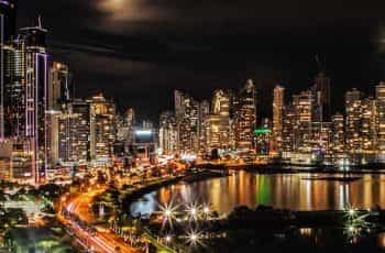 Brightly lit buildings in Panama City by night.