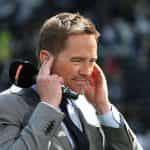 Presenter Simon Thomas holding a Sky Sport microphone.