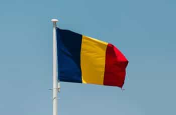 The Romanian flag against a blue sky.