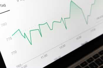 A laptop computer screen displaying a line graph, which is rising and sinking over a set period of time.